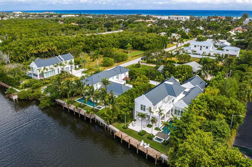 Easy breezy and beautiful..sophisticated and luxurious, this hip contemporary residence offers a dramatic view from every angle.  Just beyond the glass foyer entryway, guests are greeted by a gorgeous grand room surrounded by floor to ceiling doors affording extensive views of the Intracoastal and tropical gardens.   With 80' of direct water frontage, the home offers a superb open floor plan, which features 6182 TSF square feet, 4 bedrooms, 4.1 baths, epicurean kitchen, custom European cabinets with high gloss exotic veneers, Caesar stone and top of the line appliances from internationally acclaimed brands. Chic recessed baseboards and reglet ceiling details add to the allure of every room.  The ground floor luxurious master suite is the perfect backdrop for serenit
