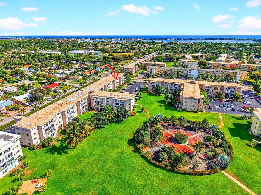 This bright third-floor 2-bedroom, 2-bath condominium is offered furnished or unfurnished and features a comfortable layout with abundant natural light. The enclosed Florida room overlooks peaceful garden views, creating a relaxing space to unwind.

Located in the desirable 55+ community of Village Royale on the Green, this residence offers elevator access and a low-maintenance lifestyle. The spacious living and dining area flows into a functional kitchen, while both bedrooms are generously sized, including a primary suite with an en-suite bathroom. A second full bathroom is ideal for guests.

Residents enjoy a wide range of amenities, including two pools and spas, a fitness center, clubhouse, card room, bocce ball, shuffleboard, and more. Rentals are permitted after two years of ownership. Conveniently located near the beach, airport, shopping, and dining. Schedule your showing today!