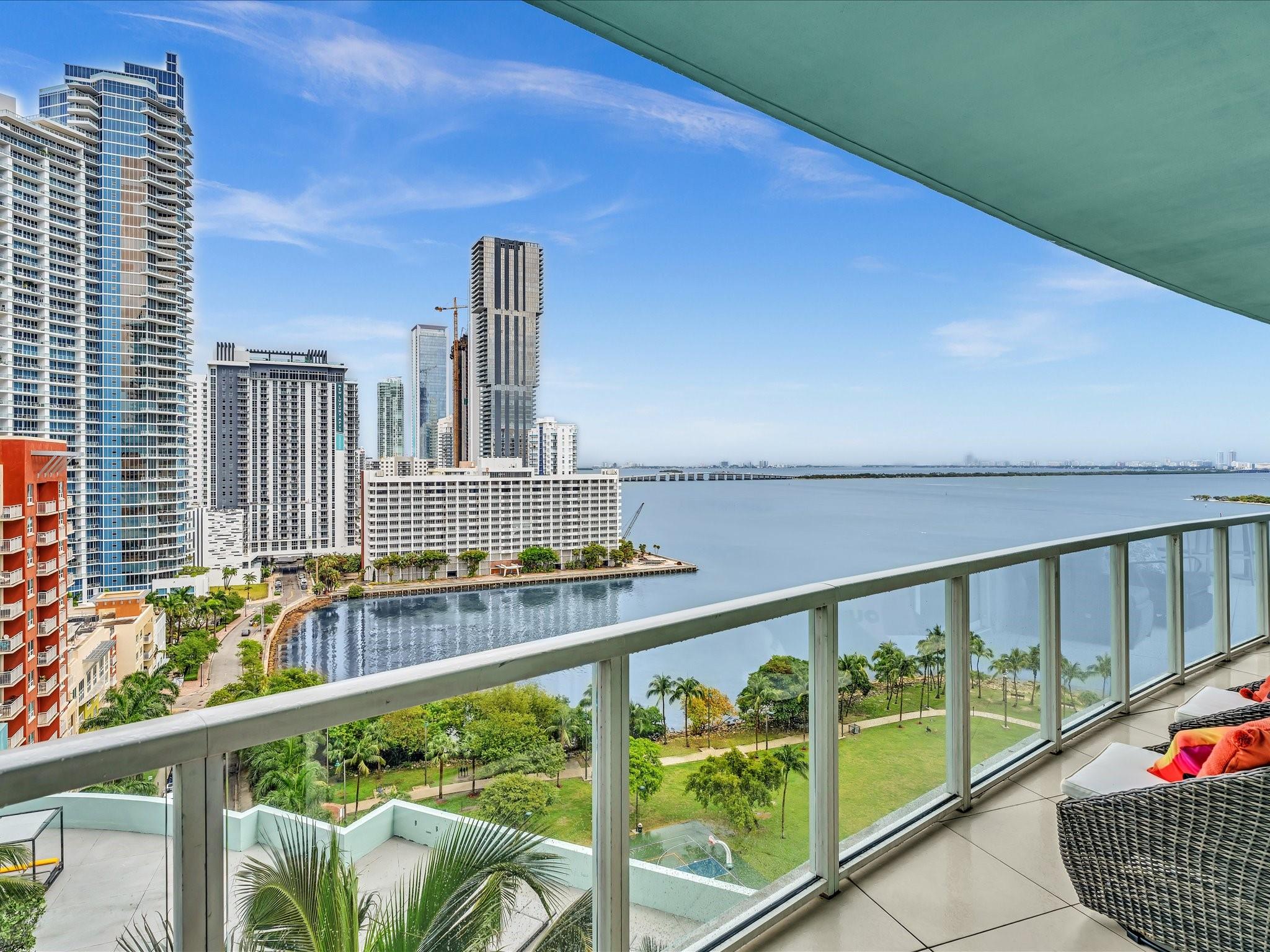 Experience the ultimate South Florida lifestyle! This stunning condo offers incredible panoramic views of Biscayne Bay & the sweeping city skyline. Wake up to breathtaking tropical sunrises from your large private balcony, accessible from both the living room & bedrooms, making every day feel like a vacation.
Inside, you'll find a beautifully updated & tastefully designed space featuring porcelain flooring, volume ceilings, electric window shades, and a sleek European kitchen w/ quartz countertops. The location w/in Quantum is one of the best, overlooking the tranquil Margaret Pace Park. For ultimate convenience, this unit features two parking spots located just steps from the elevators. Enjoy all the amazing amenities Quantum has to offer.  Art collection & designer furniture negotiable.