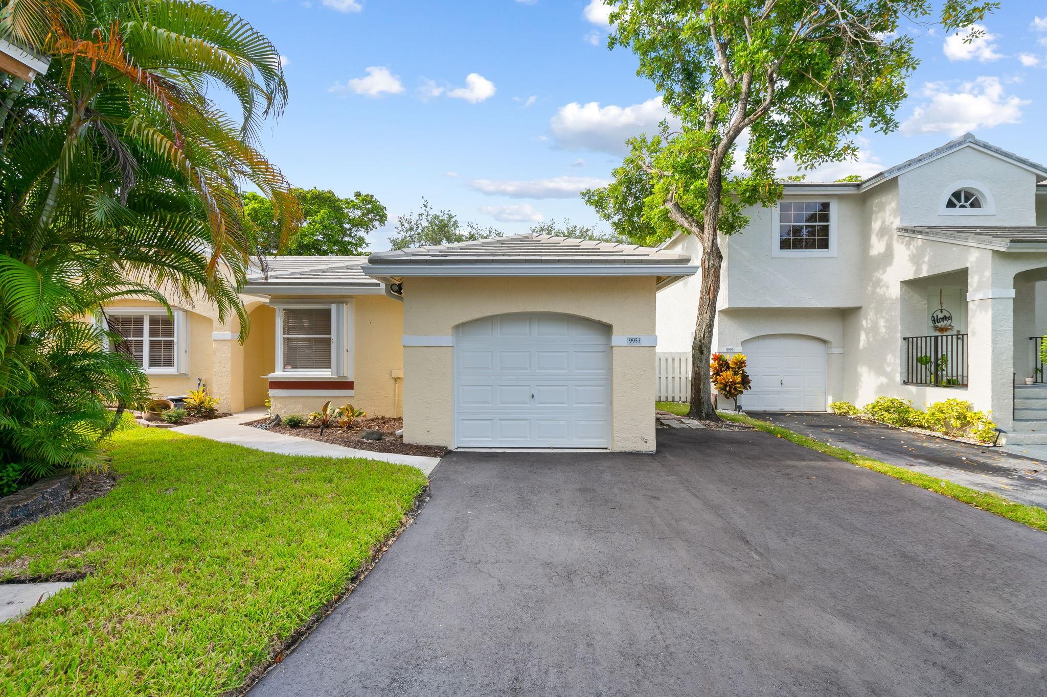 Well maintained and updated 3-bedroom, 2-bathroom plus den home located in the highly sought-after community of Quatraine III at Jacaranda. This open-concept residence boasts vaulted ceilings for a light and airy feel. Notable features include brand new, stainless steel kitchen appliances, updated bathrooms, vinyl and tile flooring throughout, fresh interior paint, an oversized fully fenced private yard, and a half garage for extra storage. Impact doors and accordion shutters provide full hurricane protection. The quiet, family-friendly neighborhood offers a community pool and playground. Centrally located near Central Park, major highways, shopping centers, restaurants, and top-rated schools. Ready for immediate occupancy.