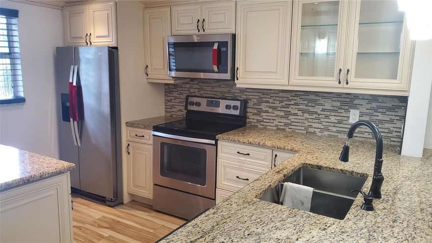 THIS IS IT! SUPER LARGE 2/2 WITH MANY UPGRADES. CUSTOM BUILT KITCHEN WITH EXRA CABINETS, GRANITE COUNTERTOPS, NEW DISHWASHER, NEWER REFRIGERATOR AND MICROWAVE, WINE COOLER, CENTRAL A/C ONLY 2 YEARS OLD, TANKLESS WATER HEATER, ALL-TILED, BUILT-IN SHELVES IN MASTER CLOSET, FRESHLY PAINTED CONDO, LARGE SCREENED-IN PATIO. WASHER AND DRYER IN UNIT. GREAT INVESTMENT IN WEST BOCA RATON!