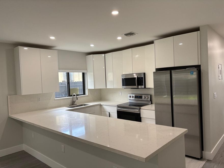 STUNNING MOVE-IN READY TOWNHOUSE! This modern 3BR/3BA residence features an open, spacious layout with premium laminate flooring and high-end finishes. The gourmet kitchen impresses with custom cabinetry, quartz countertops, and top-tier appliances. Enjoy a massive enclosed private patio, ideal for entertaining and BBQs. Spacious, sleek, and impeccably maintained.