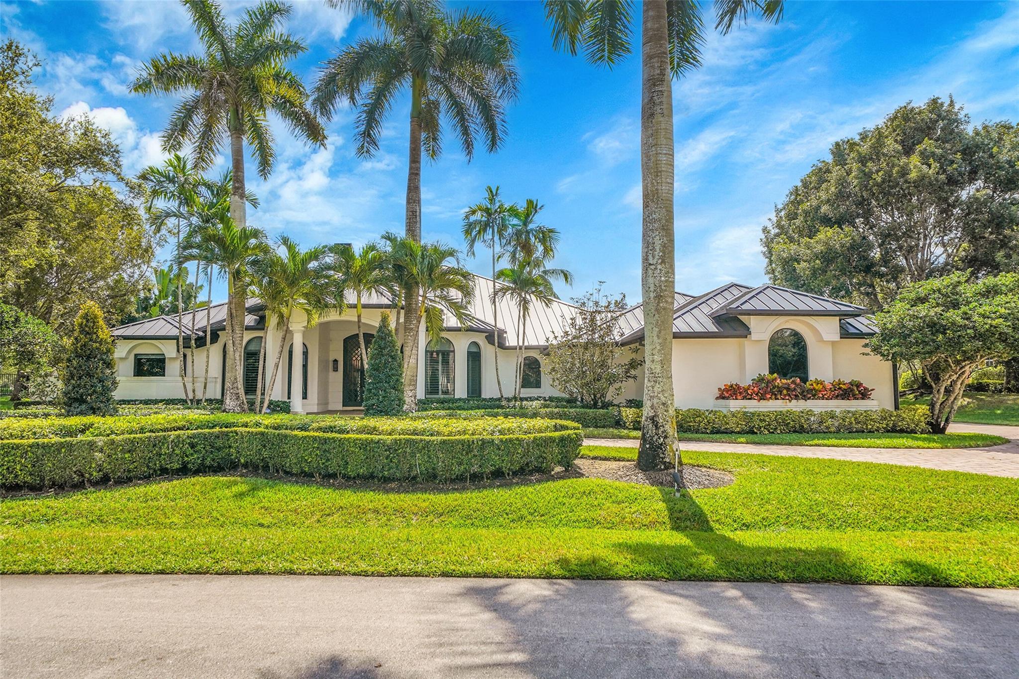 This Windmill Ranch Estates located on the quiet Street with Waterview, Windmill Ranch is Weston's most prestigious and unique community. This pristine home includes a grand circular paver driveway, a spectacular master suite, gourmet kitchen with a huge center island, a theatre, office, split plan , each bedroom has its own bathroom and closet. An amazing patio, perfect for entertaining, an oversized pool with spa and a summer kitchen/Gazebo. New metal roof and hurricane impact windows and French doors. Exterior is painted recently, lush landscaping. One-of-a-kind home, a must see, The home is price to sale. A+ schools.