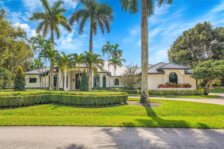 This Windmill Ranch Estates located on the quiet Street with Waterview, Windmill Ranch is Weston's most prestigious and unique community. This pristine home includes a grand circular paver driveway, a spectacular master suite, gourmet kitchen with a huge center island, a theatre, office, split plan , each bedroom has its own bathroom and closet. An amazing patio, perfect for entertaining, an oversized pool with spa and a summer kitchen/Gazebo. New metal roof and hurricane impact windows and French doors. Exterior is painted recently, lush landscaping. One-of-a-kind home, a must see, The home is price to sale. A+ schools.