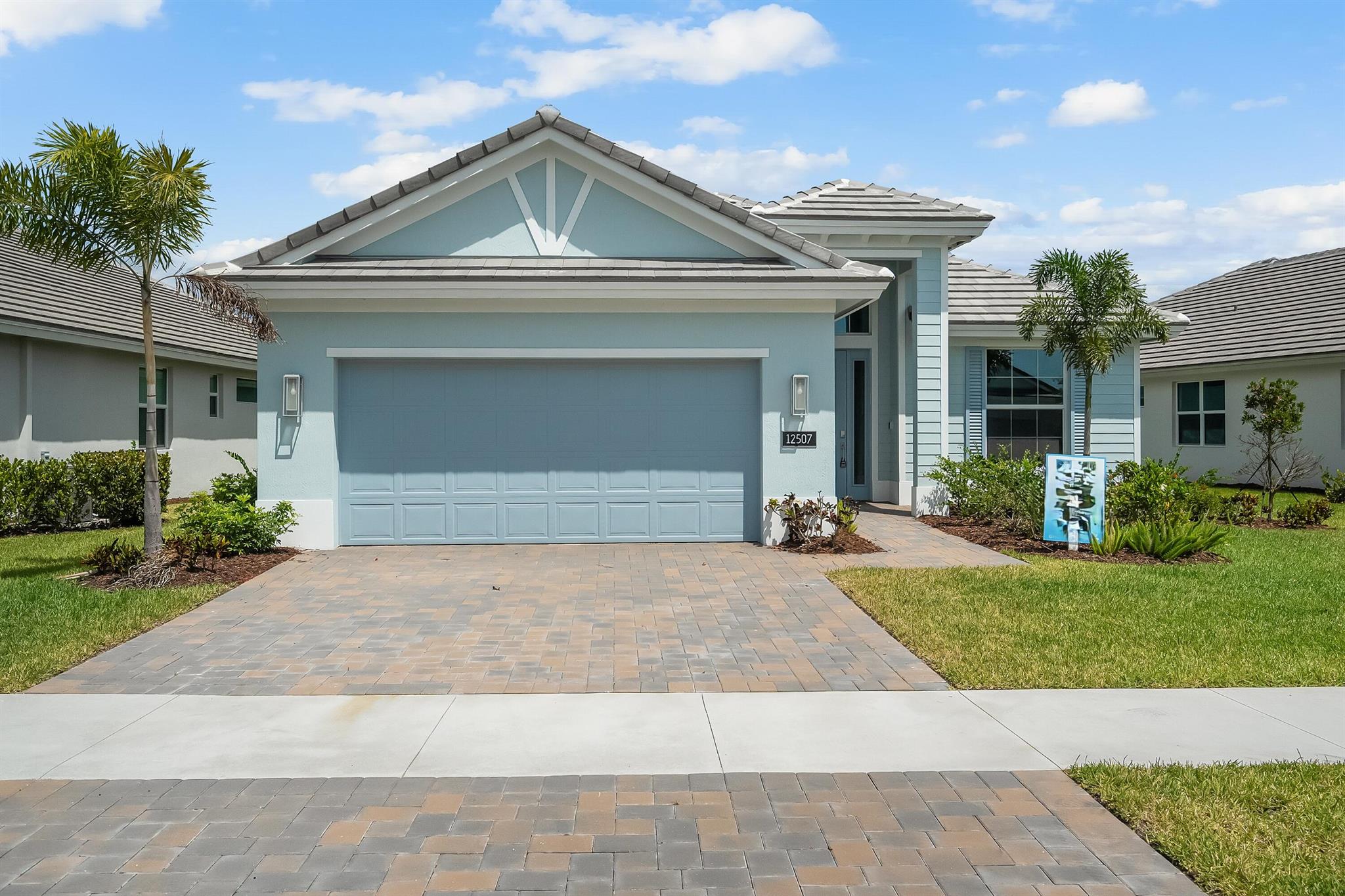 This welcoming 2 bedroom, 2 bath plus den home provides soothing colors indoors and out. The Island elevation with 4' garage extension is accented with blue and white tones. The interior is inviting with white and grey tones in the kitchen with upgraded tile backsplash, glass cooktop and double wall oven, plus 3 boxes above the kitchen island for future pendant lights. The laundry room is finished with upper and lower cabinets including a drop-in laundry tub. The office is accented with double single-lite glass French doors. Pocket door at master bath water closet. Tile flooring throughout the home plus a floor outlet and 4 hi hats in great room. The lanai is finished with an exterior wall mount TV package.