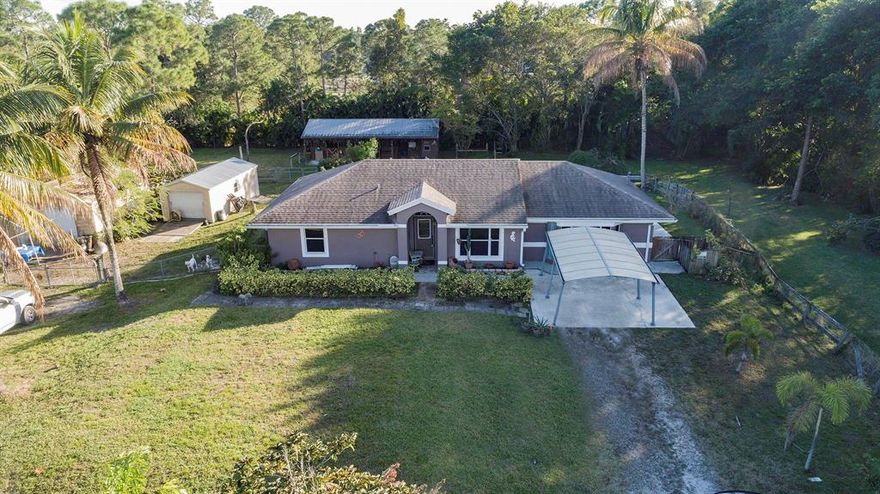 Come check out this very unique large 1 Master bedroom, 2 bathrooms with home office and large living area that sits on 1.15 acres in Loxahatchee with two large workshops/shed. This home is equipped with 2 oversized horse stables and tack room built alongside, outdoor kitchen and jacuzzi on back patio perfect for enjoy a bonfire and the great outdoors. Just a little bit of TLC needed to make it your own. Recently updated kitchen with stainless steel appliances, AC replaced within the last 3 years, Newer roof replaced within the last 4-5 years.  Come quick & Don't miss out on this amazing deal with lots of potential!