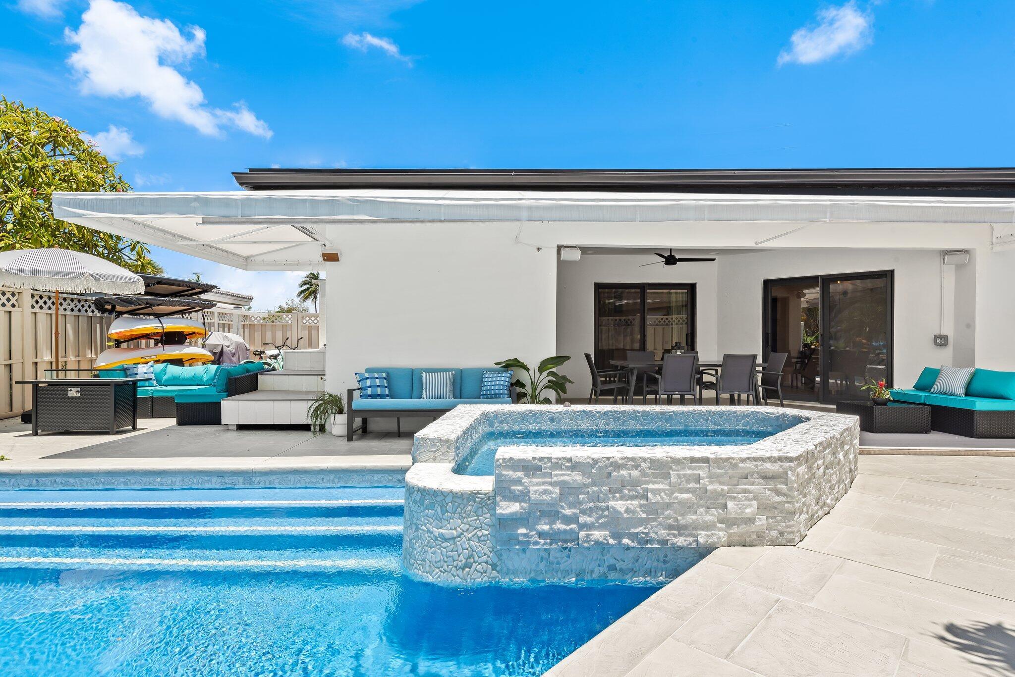 Experience coastal luxury in this fully updated 5-bedroom, 4 bath waterfront home with ocean access in East Pompano. Located on a spacious corner lot in Pompanos sought after Cypress Harbor. This 2,846sqft residence features two luxurious master suites and two guest bedrooms. The open floor plan flows effortlessly into a designers chef's kitchen complete with custom cabinetry, oversized island and 5 burner gas range. Ideal for entertaining, the home extends to a resort style pool & hot tub, outdoor lounge area, and private dock. Just minutes by golf cart to Pompano Beach Pier and nearby restaurants, with a short boat ride to Hillsboro Inlet. Enjoy the ultimate Florida lifestyle, walk from your kitchen to your boat and set off on a sunset cruise.