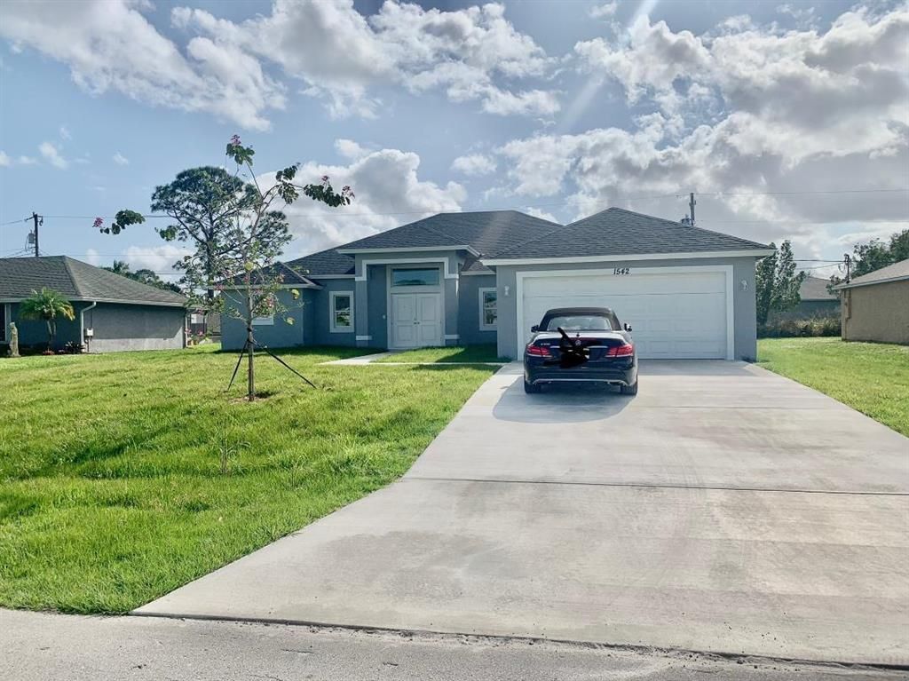 Photo of 1542 SW Pitts Avenue, Port Saint Lucie, FL 34953 (MLS # R10850451)