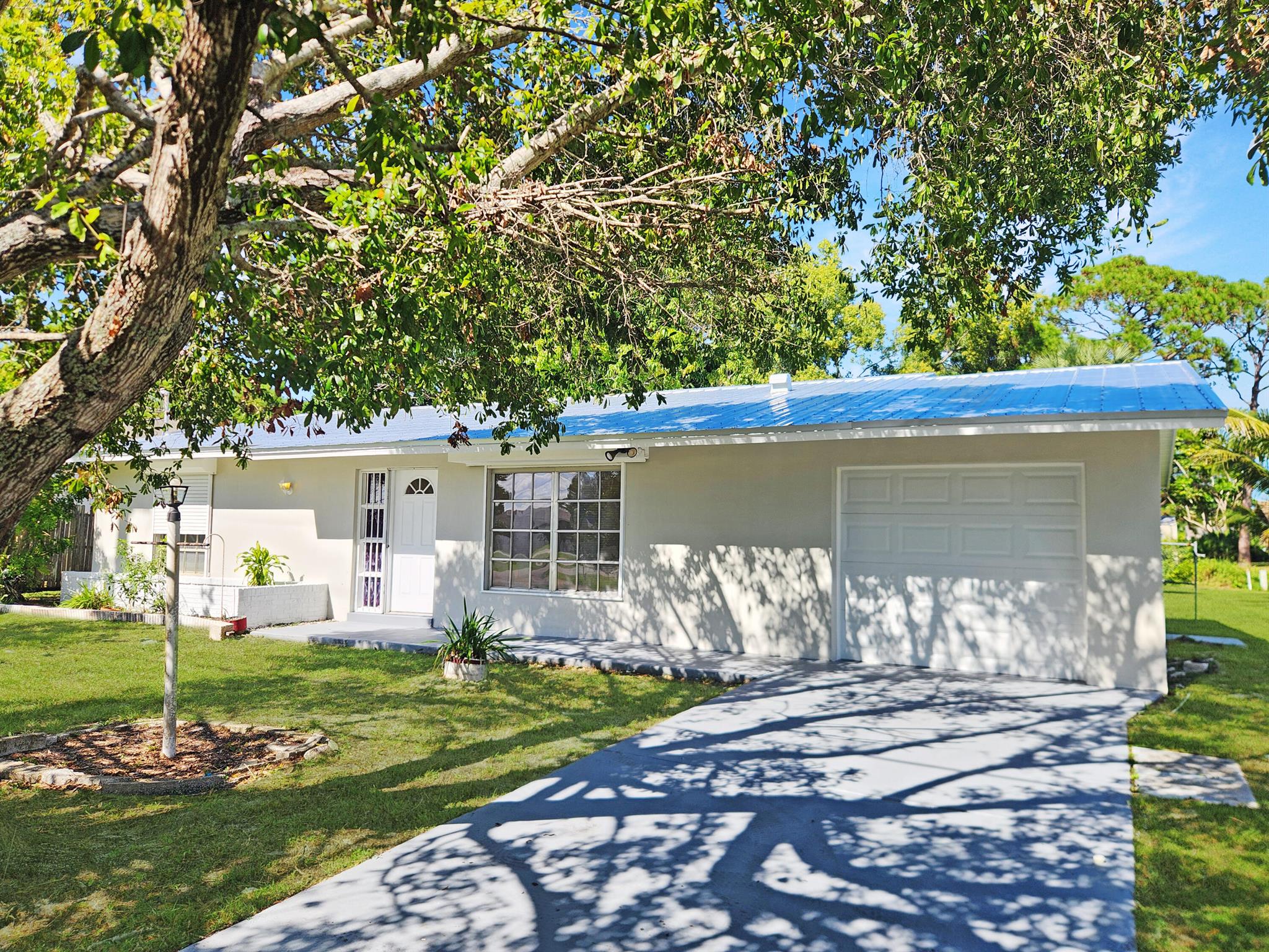 Perfect starter home centrally located in Port St. Lucie! This 2/2 solid built CBS charmer has been fully renovated and comes with a new metal roof, new garage door, and new water heater! Located on a beautiul treed lot than backs up to an easement for added privacy. Backyard fenced area makes the perfect play area for your pets! Appliances on order!