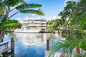 NO HOA, FEE SIMPLE WATERFRONT LOT WITH HUGE YARD AND PARKING FOR 5 CARS PLUS GARAGE! Experience Las Olas living and walk to shops, five star restaurants, and beach mile down the road. The property itself needs updating but all bedrooms are very large, master has vaulted ceilings with balcony overlooking the water and feels very much like a home with the large yard and deck space. Small Plunge pool in the back but there is plenty of space for inground. And of course no fixed bridges, minutes to waterfront restaurants and the famous sandbar which you can paddle board to for tie up parties.