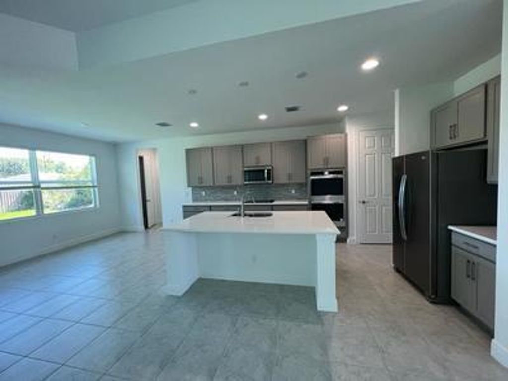 Photo of 313 SW Kestor Drive, Port Saint Lucie, FL 34953 (MLS # R11027036)