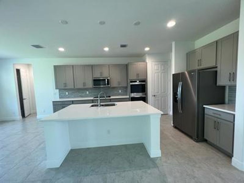 Photo of 313 SW Kestor Drive, Port Saint Lucie, FL 34953 (MLS # R11027036)