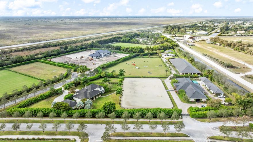 This exceptional 8.84‑acre Saddle Club equestrian estate feels like a world of its own. At its heart stands a breathtaking four‑bedroom, four‑bath residence, where an airy open floor plan flows effortlessly toward sweeping views of the 170' x 250' riding arena and the expansive three‑acre grass jump field. The home's layout is tailor‑made for entertaining, with sunlight pouring through wide windows that frame the property's most impressive equestrian features.Just steps from the main house, a charming guest cottage welcomes visitors with a warm sitting area beside a thoughtfully designed kitchenette, along with a serene bedroom complete with an ensuite bath--perfect for guests seeking privacy and comfort.For the horses, the estate offers an 18‑stall