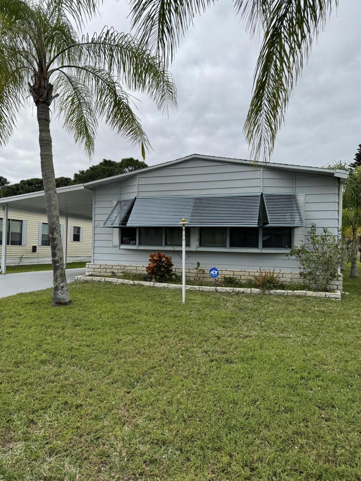 Priced for quick sale! Pet free and smoke-free! Spacious 2 bedroom 2 bathroom. Large Florida room overlooking wooded area and lovely lake view. Nice patio area. Open kitchen with cooktop stove. has a water filtration system, Large pantry, Wet bar. Laundry room inside. Both bathrooms are handicap accessible. Toilets are heated and have bidets. Hurricane shutters. A/C 2019. Roof 2014. Leaf Filtration on gutters around the house. Sold Unfurnished.