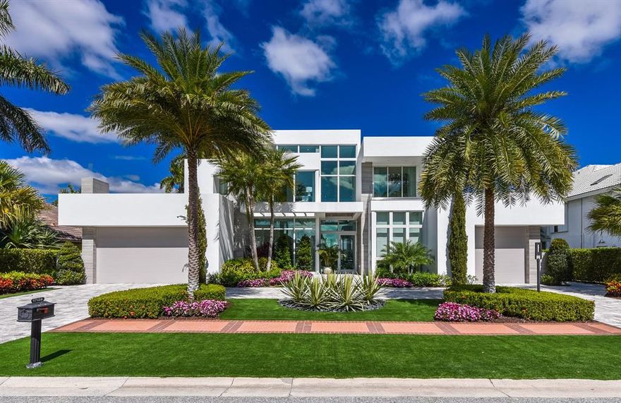 Luxury and sophistication define this contemporary style estate built in 2019 and being offered fully furnished. This strikingly elegant residence, with over 6200 sq ft of living area features magnificent architecture and exquisite custom finishes throughout. The grand entrance foyer with floating signature staircase opens to a centrally located living room with stunning floor to ceiling windows creating the ultimate atmosphere for entertaining or casual relaxation. A central fireplace separates the living and family rooms. A stunning glass wine room separates this space from a gourmet chef's kitchen, and dining areas. A luxurious first floor master suite features perfectly appointed his and her baths and generous built in closets. Also located on the first floor is an office and spacious guest suite. Upstairs, the second floor features 3 additional en suite bedrooms and large entertainment area. Views from the interior overlook sweeping lake and golf course vistas, a sparkling resort style pool, spa, covered loggia and summer kitchen. Additional features include elevator, impact glass, air conditioned garages, and whole house generator. The information herein is deemed reliable and subject to errors, omissions and changes without notice. All measurements are approximate.