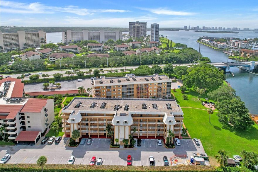 The seller has paid all assessments--move right in and enjoy this amazing community! Take in breathtaking views from the spacious balcony as boats glide by. The beautifully maintained grounds feature a lush lawn overlooking the water and the North Palm Beach Country Club Golf Course. Relax under majestic banyan trees, fish off the dock, or host a cookout with community grills. The sparkling heated pool is perfect for unwinding or socializing, while the clubhouse offers amenities like a kitchen, small gym, and library. Residents also enjoy access to the town's library, tennis courts, golf course, Olympic-sized pool, and seasonal events. With yoga, pickleball, book clubs, and activities for all ages, North Palm Beach is a charming town with an exceptional quality of life!course, and an