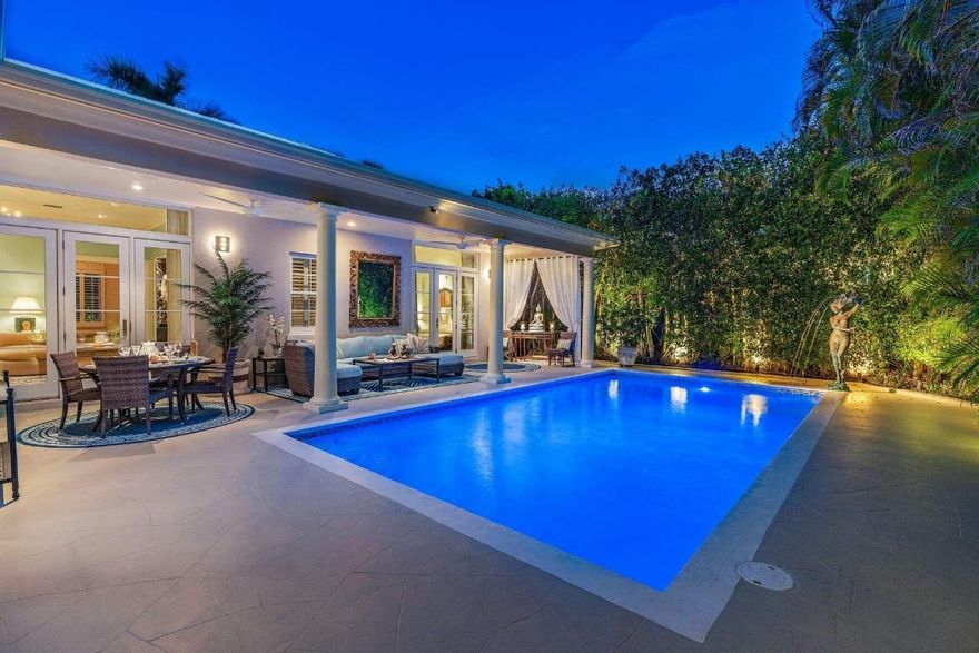 IMPRESSIVE, 1 story, Palm Beach Regency, refined & updated, w approx. 14' ceilings in the great room & high ceilings throughout. This near north Gem, on Corner lot, just south of The Beach Club is 300' from an accessible beach. The 4BR, 3.1BA home has 2 primary bedrooms w ensuite baths. A 3rd bedroom, w ensuite bath, may be shared, w the 4th BR/office w murphy bed. Loggia overlooks stunning, saltwater pool & bronze fountain-ideal for entertaining, flows beautifully from all major rooms. This estate's floor plan is versatile & lends itself to suit your needs, offering a sophisticated residence, that's a turnkey alternative to a condo. Secured w gates, walls/hedges & security system/cameras, w impact windows/doors & Full House Generator. 3 car AC garage &  motor court.