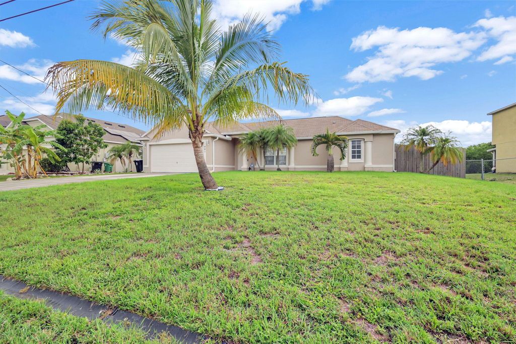 Photo of 441 SW Feldman Avenue, Port Saint Lucie, FL 34953 (MLS # R11002143)
