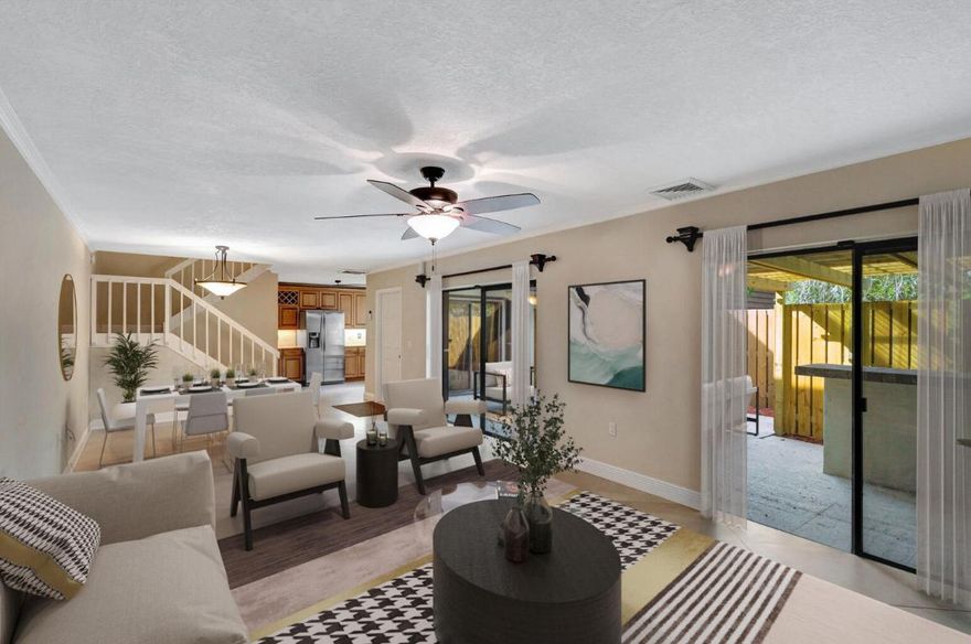 Welcome to your dream townhome in the heart of Palm Beach Gardens! With the largest living area in the community, this 2-bedroom, 2.5-bathroom residence seamlessly combines comfort and style.

The chef's kitchen features granite countertops, a custom storage island, and stainless steel appliances, perfect for both cooking and entertaining. Accordion shutters provide security, and a gas fireplace adds warmth and elegance to the living space. Step outside to the newly fenced patio, a private oasis with a built-in BBQ and spacious storage.

Equipped with a new AC and gas water heater, the townhome ensures year-round comfort. Downstairs boasts gorgeous porcelain tile flooring, while upstairs features beautiful wood floors. Wake up to serene lake views from the two bedrooms.