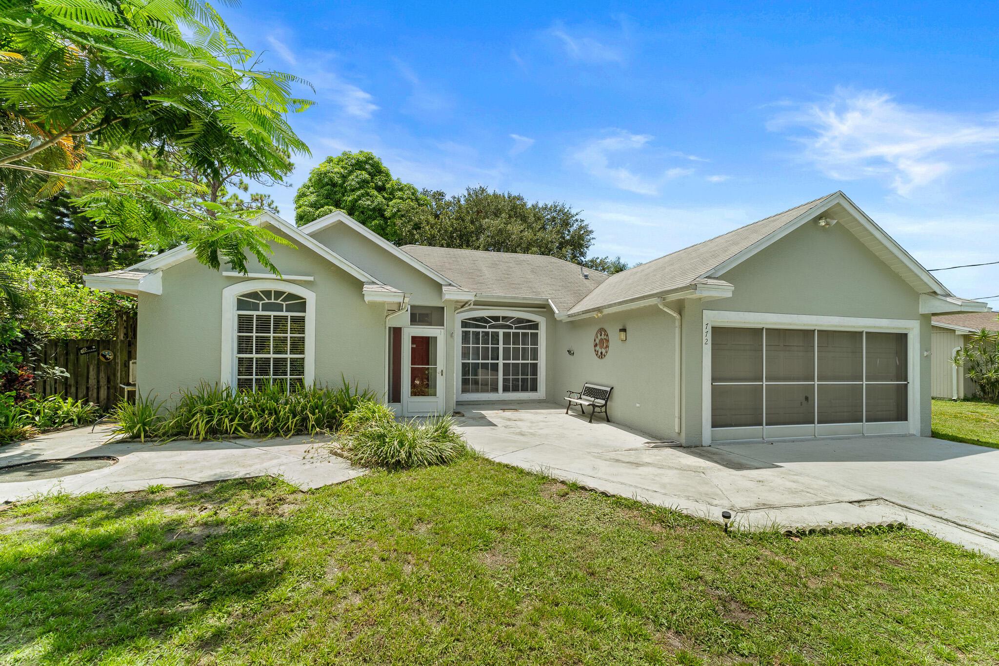 Welcome to 772 NW Avens St, a beautifully updated 3 bed, 2 bath CBS home with a 2-car garage in Port St. Lucie. Inside, enjoy vaulted ceilings, a spacious layout, and a renovated kitchen and bathrooms that blend style and function. The split floor plan offers privacy, while the 2-car garage provides added storage and convenience. Step outside to a fully fenced backyard surrounded by mature oak trees and tropical foliage--ready for a pool, garden, or custom outdoor retreat. Located in a quiet, established neighborhood close to shopping, dining, and I-95, this move-in-ready home offers comfort, character, and endless potential.