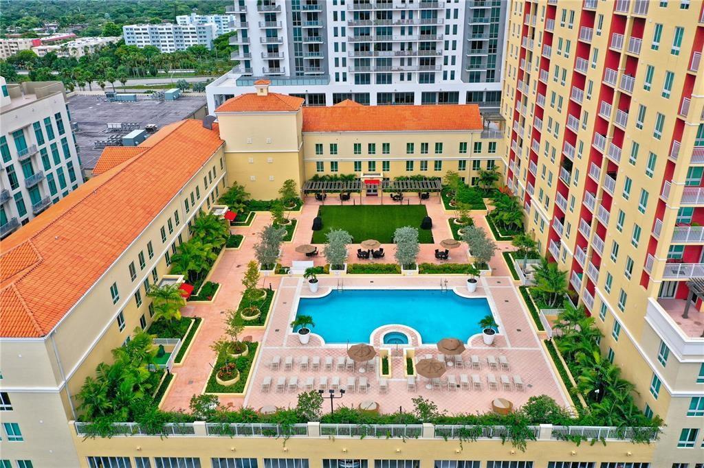 ONE OF A KIND! Oversized corer layout 1006 sqft + 95 sqft balcony! 2nd bedroom is an open space with tons of windows (currently a huge den area - 11.8 x 16 feet long). Modern wood /laminate flooring, granite countertops, washer/dryer in unit and a big walk-in closet. Extra-large balcony with a bright and open southeast view. Building offers front desk reception with 24-hour concierge services and valet parking. Beautiful pool and barbeque area, social rooms and state of the art fitness center with lockers and saunas. Cable, internet, water, sewer, trash and 1 assigned parking included. Enjoy an incredible location with easy access anywhere... right downstairs you have restaurants and coffee shops, easily walk to Publix, Trader Joes, 4 banks and even a metro rail stop 2 blocks away!