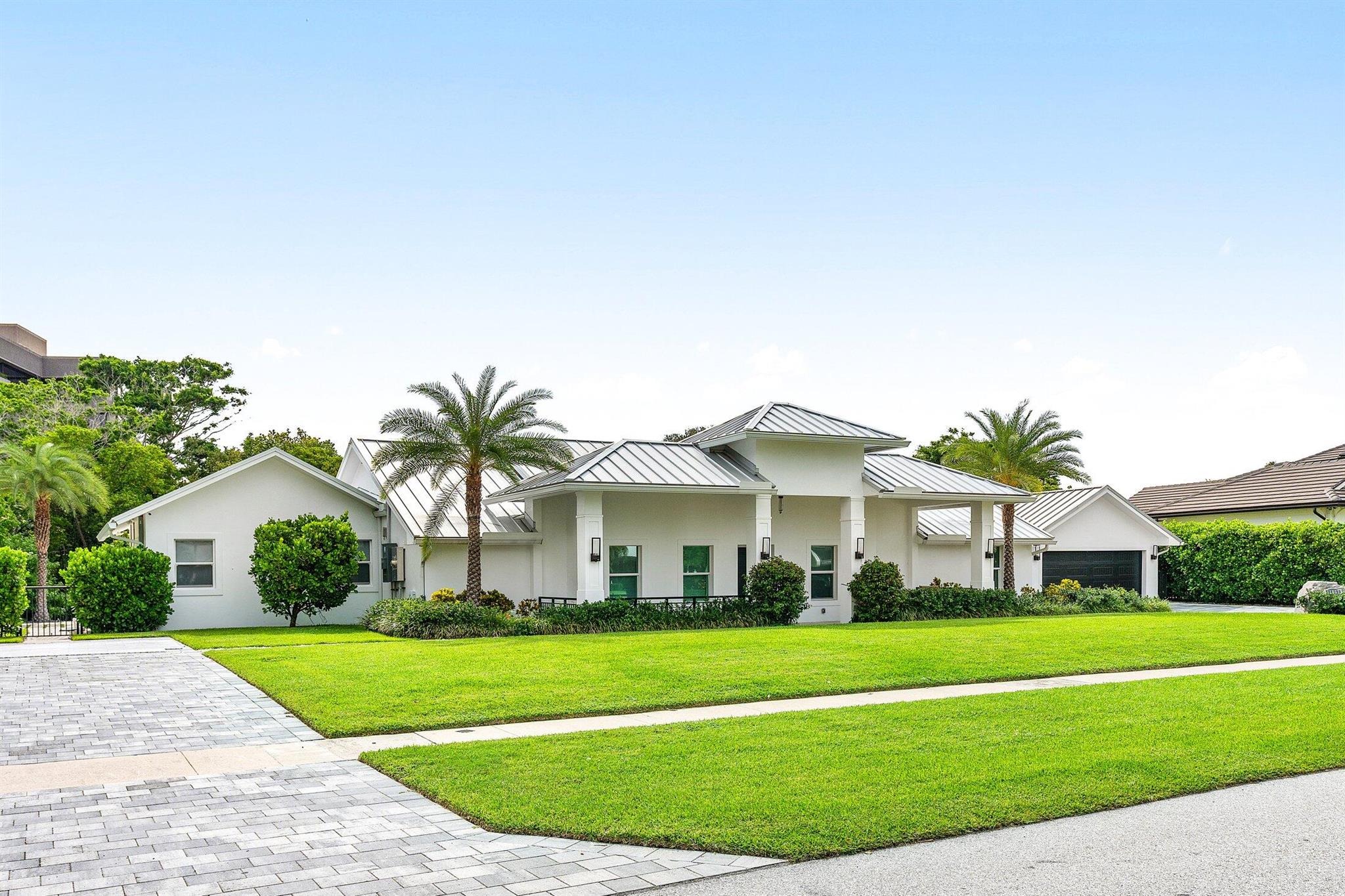 Whole house renovation and Master Bedroom addition in 2022, including new roof, AC units, electrical, plumbing. New trusses elevated ceilings to nearly 12 feet. Hidden Key is one of the most highly sought after communities, offering an ideal location, private gated entry, no HOA fees. This immaculate estate provides the ideal Florida lifestyle with its sophisticated design and high end amenities, including; Miele appliances, custom solid wood cabinetry, and quartz surfaces. Enjoy your spacious, private outdoor space with salt system automated pool, sun shelf, and 16 person spa, brand new outdoor kitchen and bar, and 146 feet of private canal and new synthetic dock for up to a 22 foot boat. The home also offers a 2 bdrm guest house, a perfect in-law suite, or rooms for older children.
