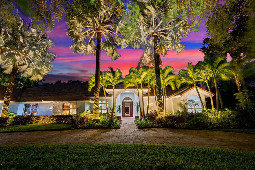 Welcome to this breathtaking 5-bedroom, 3.5-bath estate in the exclusive, guard-gated community of Fieldbrook Estates in the heart of Boca Raton. Situated on a full 1-acre lot of lush, tropical landscaping, this home offers the ultimate blend of privacy, elegance, and South Florida living. Flooded with natural light, the bright, modern interior showcases gorgeous updates and luxurious finishes at every turn. The expansive primary suite is a true retreat — a huge bedroom paired with a stunning, spa-like bath designed for ultimate relaxation. A sleek wet bar and a gorgeous gourmet kitchen with high-end appliances elevate the home's everyday comfort and entertainment appeal. Impact windows and doors throughout provide peace of mind and efficiency. The backyard is a resort-inspired paradise. Retractable screens separate a portion of the outdoor space, while beyond them awaits the rest of the incredible yard. Enjoy a sparkling pool and hot tub, a charming gazebo surrounded by lush gardens and colorful flowers, and a separate fire pit area perfect for relaxing under the stars. At night, the entire yard is illuminated with vibrant, color-changing lighting, creating a magical ambiance. With a massive driveway and spectacular indoor-outdoor amenities, this home truly embodies luxurious Boca Raton living - a rare opportunity in one of the area's most prestigious neighborhoods.