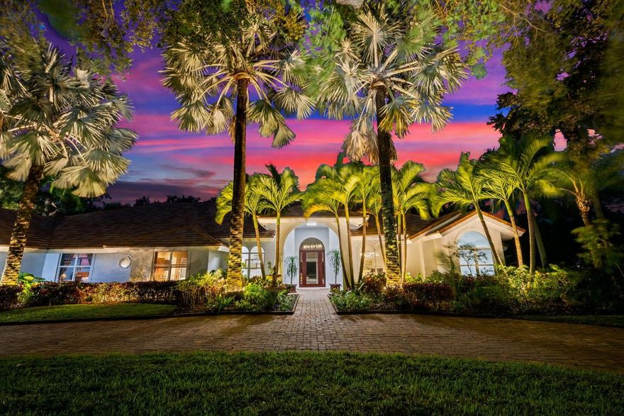 Welcome to this breathtaking 5-bedroom, 3.5-bath estate in the exclusive, guard-gated community of Fieldbrook Estates in the heart of Boca Raton. Situated on a full 1-acre lot of lush, tropical landscaping, this home offers the ultimate blend of privacy, elegance, and South Florida living. Flooded with natural light, the bright, modern interior showcases gorgeous updates and luxurious finishes at every turn. The expansive primary suite is a true retreat — a huge bedroom paired with a stunning, spa-like bath designed for ultimate relaxation. A sleek wet bar and a gorgeous gourmet kitchen with high-end appliances elevate the home's everyday comfort and entertainment appeal. Impact windows and doors throughout provide peace of mind and efficiency. The backyard is a resort-inspired paradise. Retractable screens separate a portion of the outdoor space, while beyond them awaits the rest of the incredible yard. Enjoy a sparkling pool and hot tub, a charming gazebo surrounded by lush gardens and colorful flowers, and a separate fire pit area perfect for relaxing under the stars. At night, the entire yard is illuminated with vibrant, color-changing lighting, creating a magical ambiance. With a massive driveway and spectacular indoor-outdoor amenities, this home truly embodies luxurious Boca Raton living - a rare opportunity in one of the area's most prestigious neighborhoods.