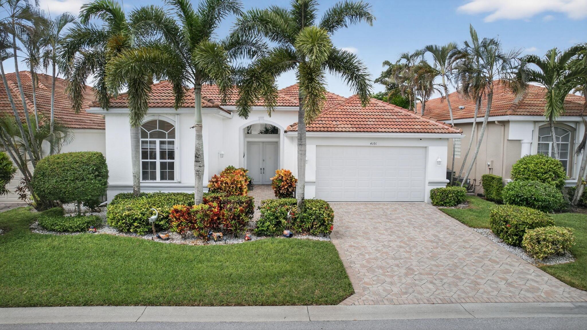 Rarely available courtyard model in Laurel Estates. This stunning home features a private courtyard w/ a large patio & pool surrounded by lush landscaping, plus an oversized 1BD/1BA guest suite with direct courtyard access, ideal for in-laws or guests. The beautifully updated kitchen offers white quartz countertops, white cabinets with pull-outs, and new appliances. Elegant gray & white French porcelain tile flows throughout. The primary suite features new impact French doors that open to the back patio with beautiful lake and golf course views. The great room and dining areas share the same scenic view. A full security system with cameras and remote access adds peace of mind, while the pool area includes a custom safety gate and tasteful blue accent decor for a tranquil outdoor retreat.