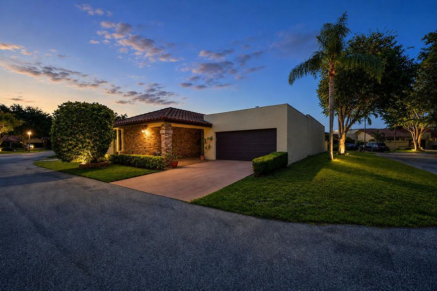 Nestled within the prestigious Boca Raton community of Pradera, this impeccably maintained and exceptionally clean pool home presents an incredible opportunity to own a beautifully cared for residence in one of Boca's most desirable neighborhoods. Offering nearly 2,200 square feet under air and nearly 3,000 total square feet, this residence is complete with 3 full-size bedrooms, 2 full-size bathrooms, an oversized 2-car garage, and your own private screened-in pool designed for year-round enjoyment. Perfectly positioned on a large quiet corner lot with added privacy, expanded outdoor space, and convenient guest parking nearby, the property also features an expansive butterfly garden area with endless possibilities to create a truly spectacular outdoor retreat. Proudly owned and meticulously cared for by the original owners, the home showcases an expansive open-concept floor plan filled with soaring ceilings, abundant natural light, timeless architectural character, and exceptionally maintained living spaces that immediately reflect true pride of ownership. The home has seen important updates throughout ownership, including replaced bathroom countertops, a 2018 air conditioning system, 2021 water heater, and a roof approximately 15 years old. The kitchen is not original and was remodeled roughly 20 years ago with large cabinetry that has been impeccably maintained, Corian countertops, and stainless steel appliances, offering a great balance between functionality and opportunity for future customization.  Expansive sliding glass doors flood the interior with sunlight while creating a seamless indoor-outdoor flow ideal for both entertaining and everyday living. A soaring cathedral ceiling elevates the expansive main living area, creating an airy and inviting atmosphere filled with natural light, while the impressive floor-to-ceiling stone fireplace serves as a striking architectural centerpiece that adds warmth, scale, and timeless character to the home. Additional interior highlights include vaulted ceilings, walk-in closets, a dedicated laundry room, oversized garage space, and perfectly maintained carpeting that has been replaced and cared for over the years as needed.  The generously sized primary suite offers direct access to the pool area and features two large closets, providing abundant storage and functionality. The spacious primary bathroom includes a massive dual vanity, a large soaking tub, and a separate walk-in shower, creating an ideal layout with endless potential to customize into a true spa-like retreat. Two additional bedrooms are thoughtfully tucked away down a private hallway, creating ideal separation and comfort for guests, family members, or housemates.  Step outside into an oversized screened-in pool and patio area perfectly suited for relaxing or entertaining in complete privacy. The expansive side yard and charming butterfly garden create a peaceful outdoor setting with plenty of space to enjoy as-is, whether for gardening, entertaining, relaxing outdoors, or simply appreciating the added openness and privacy that comes with the oversized corner lot. Located just minutes from Town Center at Boca Raton, A-rated schools, dining, shopping, houses of worship, and with easy access to both I-95 and the Florida Turnpike, this location offers an unbeatable combination of lifestyle and convenience. The HOA further enhances ownership by covering lawn care, sprinklers, cable, trash removal, reserves, pool service, professional management, and alarm monitoring, providing exceptional value and peace of mind.  This is truly a rare opportunity to secure a lovingly maintained original-owner residence with incredible bones, timeless character, exceptional pride of ownership, and unlimited potential, all within one of Boca Raton's most sought-after communities.