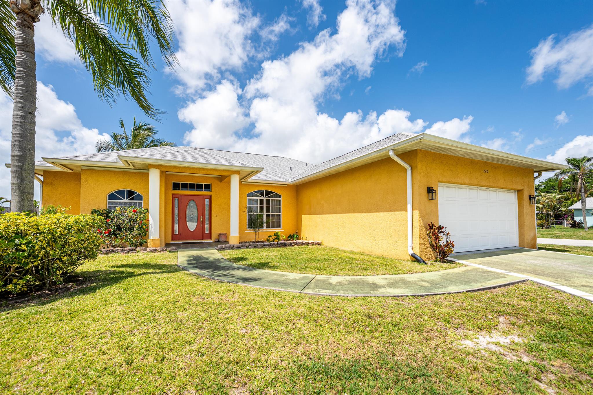 PRICE REDUCTION: Discover this charming 2003 custom 3-bedroom, 2-bathroom home, full of character and offering great value. Recent upgrades include a new roof (2024), water heater (2022), and AC (2020) with a HEPA filter and U.V. light. Additional features include a well/sprinkler system, whole-house water filtration, & a convenient cabana bath. on a spacious ⅓-acre corner lot, the property is fully fenced and provides plenty of space for a pool or boat. The recently re-plumbed kitchen boasts stainless steel appliances, a new dishwasher, & cozy breakfast nook. Throughout the home, you'll find stylish ceramic tile flooring.Located in the sought-after River Park neighborhood of Port St. Lucie, this home is just minutes from shopping, dining, schools, beaches & high