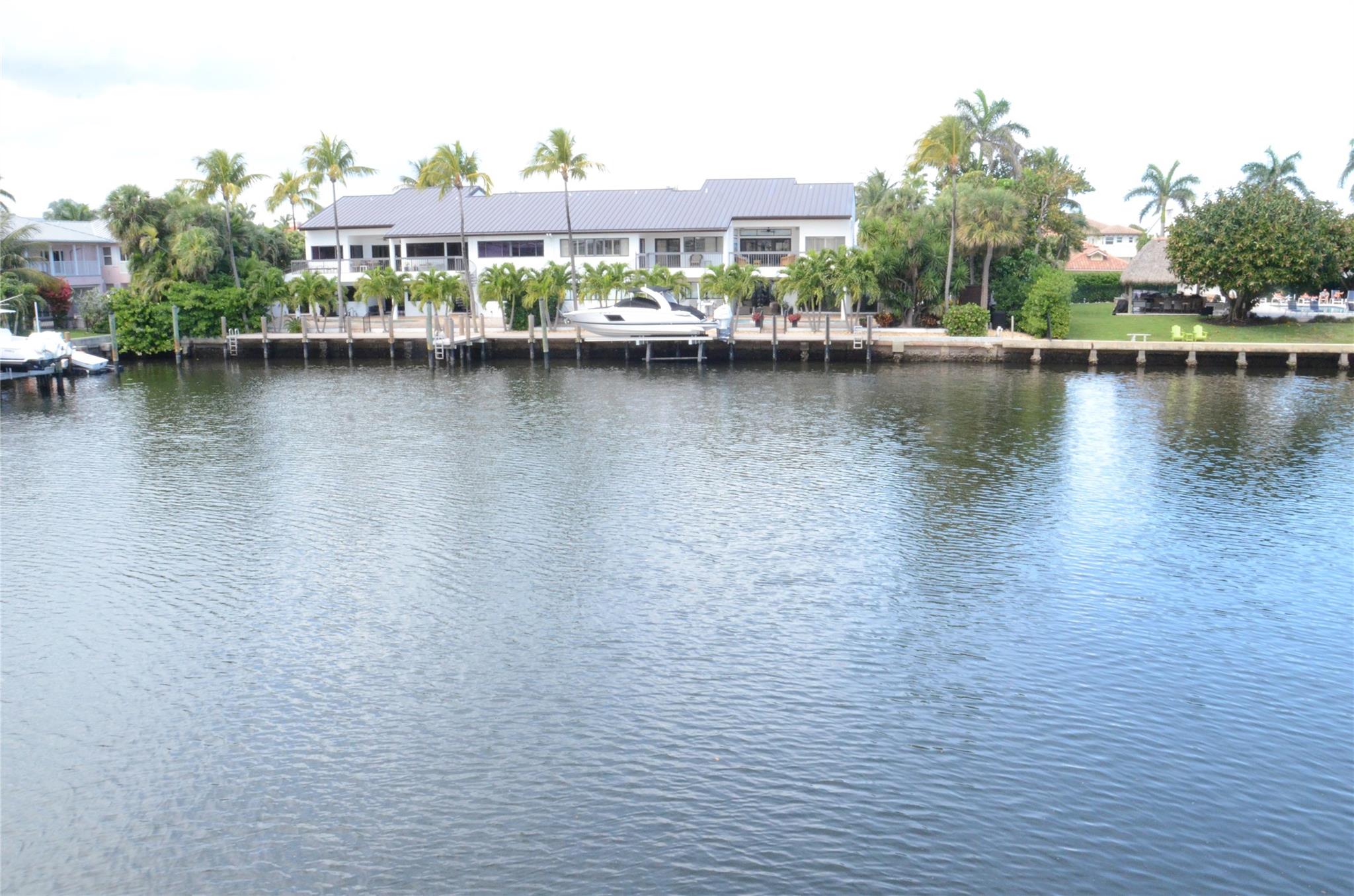 Sprawling 3 bedroom, 2 bath bright & airy residence on main level features 38' dock & use of private pool , patios, outdoor shower, cabana baths & bbq! Property direct on the Intracoastal-A boater's delight! No fixed bridges! Set back in wide lagoon with stunning waterviews! Remodeled throughout-fully furnished!!! Spacious granite kitchen/stainless applicances. Main & master baths both renovated. Picturesque impact windows & doors & tile floors throughout! Huge master suite with slider to private patio & waterviews! All large bedrooms with great closet space. Expanded paver driveway with 2 spots for tenants. Walk to beach across the street!!! Minutes to shopping, restaurants & downtown!!! A vacation delight-just bring your toothbrush!!!