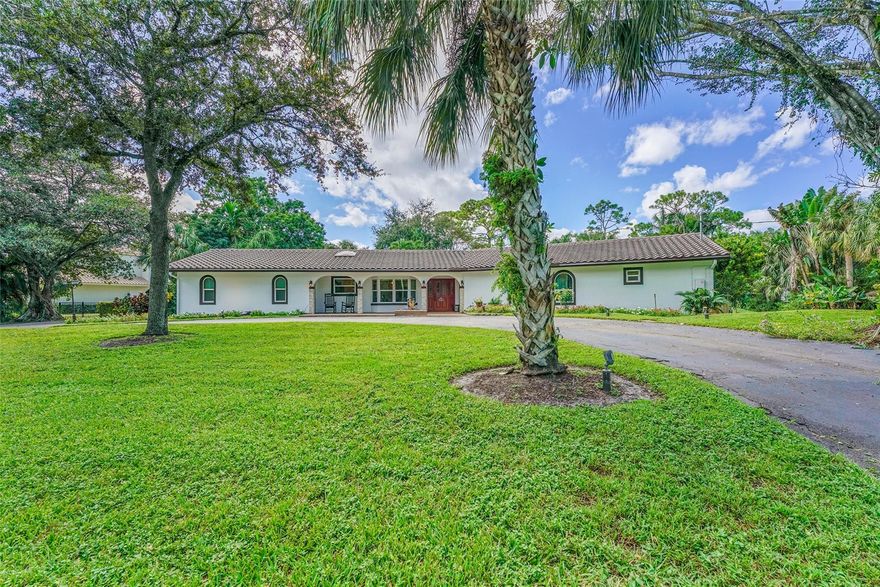 Beautiful Mediterranean updated family compound/estate home and guest houses on approx three (3) acres of land in Parkland offering country living, privacy and endless opportunity. The spacious main house features 3 bedrooms and 3 bathrooms with an office/den, gym and living areas that are ideal for entertaining. The property also features two (2) spacious guest apartments with 2 bedroom and 2 bathrooms each featuring spacious accommodations for guests and/or in-laws. The outdoor pool and 1700sf gazebo are ideal for entertaining, grilling and pizza making on the built in pizza oven. Bring your boat and/or RV and store it in the large outdoor garage. The property has many mature palm trees and acres of limitless potential. Come see this unique property ASAP as it will not last.