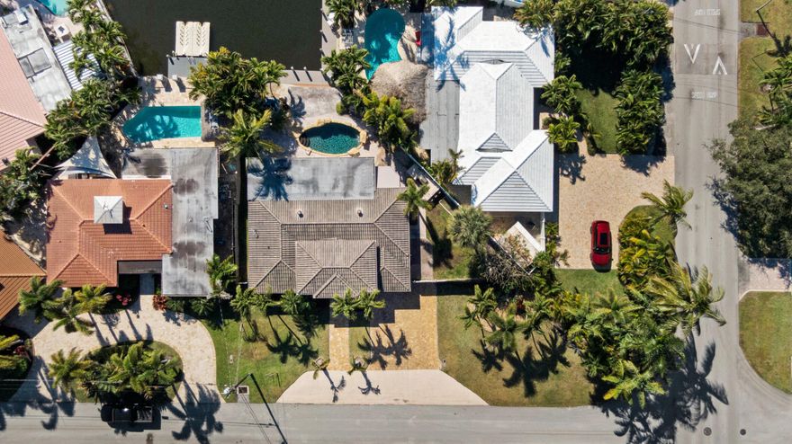 Located in the highly sought-after The Cove neighborhood of Deerfield Beach, this 2-bedroom, 2-bath waterfront home offers ocean access, a NEW private dock, and is less than five minutes from the beach, with NO HOA. 
Set along the water with two fixed bridges, the property features its own private dock and a tropical backyard designed for relaxed South Florida living. A free-form pool with rock detailing and a waterfall feature creates a resort-style setting. Rinse off in the heated outdoor shower after a day on the water or at the beach.
Inside, volume ceilings welcome you into a spacious entry and an open-concept great room designed to maximize light and water views. Modern herringbone-pattern ceramic tile runs throughout the main living space creating a clean, contemporary feel. The primary suite serves as your own private retreat with direct access to the backyard,  walk-in closet with custom built-ins, and an open-concept spa-style bathroom featuring a separate walk-in shower, and jacuzzi tub. 
Additional highlights include a travertine driveway, impact glass and accordion shutters for added protection, and fiber optic recently added to the neighborhood. 
With close proximity to the beach, ocean access boating, and one of Deerfield Beach's most desirable neighborhoods, this home offers an exceptional opportunity for full-time living, a coastal getaway, or a long-term investment.
Deerfield Beach is one of South Florida's fastest-growing coastal communities, known for its award-winning beaches, walkable fishing pier, vibrant dining scene, and strong sense of community. The area offers a relaxed beach-town atmosphere supported by amenities that appeal to both full-time residents and seasonal visitors.
With convenient access to major highways, airports, parks, top-rated schools, golf courses, and premier pickleball facilities, Deerfield Beach provides an easy, connected lifestyle. For travelers and commuters, you'll have easy access to US-1, I-95, and the Sawgrass Expressway/Turnpike on ramp via SW 10th St. FLL Int'l Airport is about 25 minutes away, Miami Int'l Airport is 40 minutes away, and Palm Beach Int'l Airport is about 30 minutes away. Whether used as a primary residence, vacation retreat, or long-term investment, the area continues to attract buyers seeking coastal living with everyday functionality.