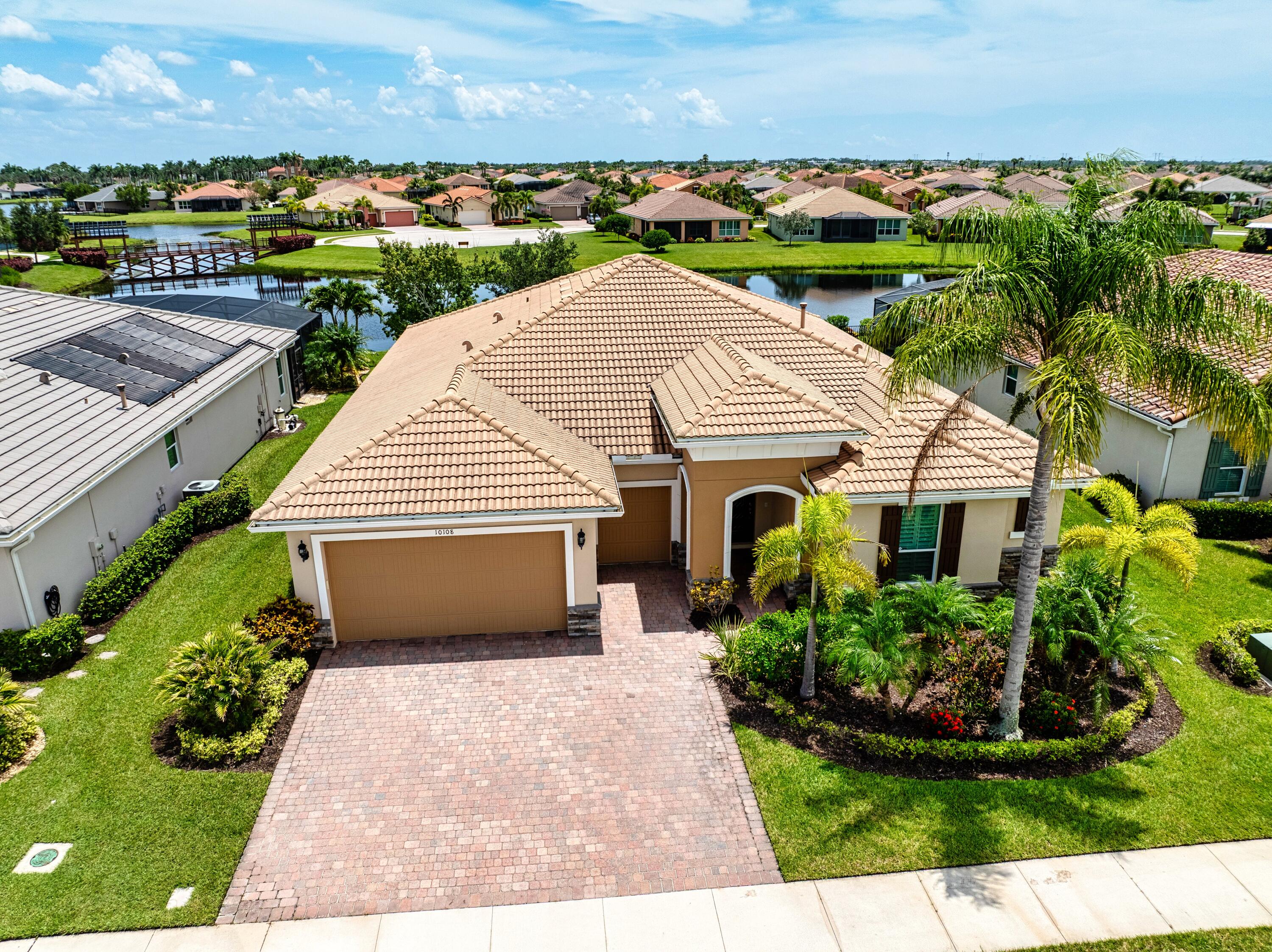 This beautifully upgraded 3 bedroom, 2.5 bathroom home with a versatile den offers over 2,400 sqft of luxurious living space. Impact windows and a durable tile roof provide peace of mind, while the extended garage with a dedicated golf cart bay adds extra convenience. Inside, you'll find a spacious open-concept family room with soaring trey ceilings and elegant crown molding, seamlessly connected to a stunning gourmet kitchen featuring high-end finishes--perfect for entertaining. Step out to your extended screened lanai and take in the breathtaking lake views. The oversized master suite boasts dual walk-in closets, dual vanities, a soaking tub, and a walk-in shower for a spa-like retreat. The den is thoughtfully positioned off the master and family rooms, with direct access to the patio,