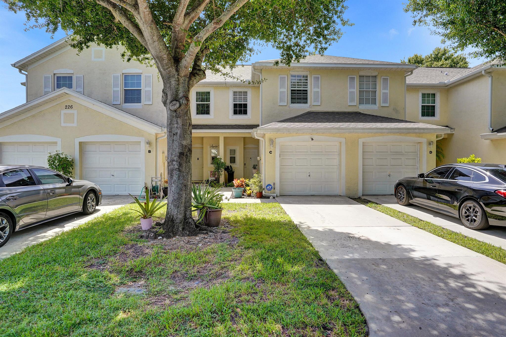 TURN-KEY. A newly renovated townhome awaits in Charter Club of Greenacres. This 3 bedroom, 2.5 bath townhome is freshly painted with full impact windows throughout, brand new porcelain floors and updated bathrooms. A/C, Roof & Water Heater were updated in 2023! The kitchen boasts soft close cabinets, quartz countertops, top-of-the-line Samsung appliances and brand new Kitchenaid Oven/Stove and a built in bar with an electric fireplace. Brand new Washer/Dryer. Brand new epoxy flooring in the garage and outdoor patio! Plenty of guest parking. Spend your weekends in the sun relaxing at the community pool! Non-rental community. Turnkey with nothing to worry about!