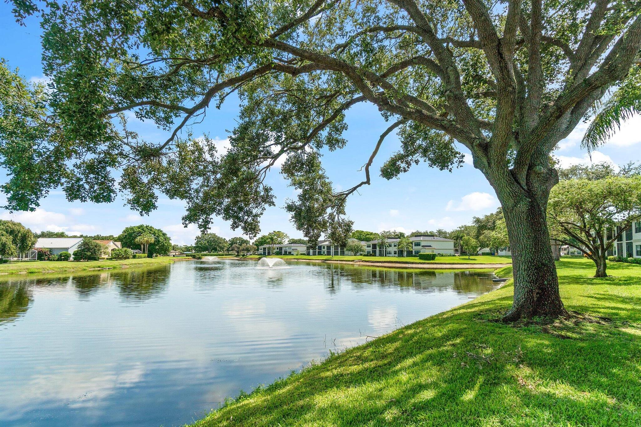 Superior in every way! This stunning fully renovated 2-bedroom, 2-bathroom condo in prestigious Eastpointe Country Club offers breathtaking lake views and modern elegance. The open-concept interior features vaulted ceilings, sleek contemporary ceramic tile flooring throughout and a modern kitchen with LG appliances and quartz countertops. The primary bedroom includes a spacious bathroom with dual sinks and a glass enclosed shower & spacious walk-in closet. Other features include a new metal roof (2024), upgraded plumbing & fresh exterior paint. Enjoy serene lake views from the screened patio perfect for relaxing & enjoying the ultimate Florida lifestyle. Community amenities include a pool & BBQ area.