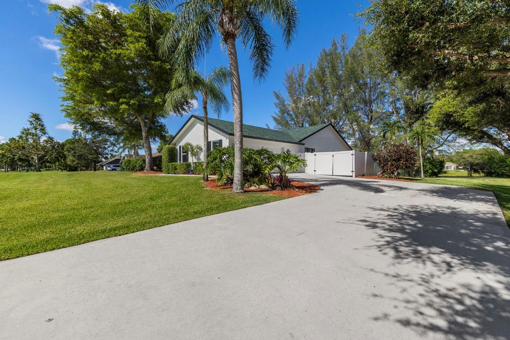 Photo of 825 Whippoorwill Trail, West Palm Beach, FL 33411 (MLS # F10530005)