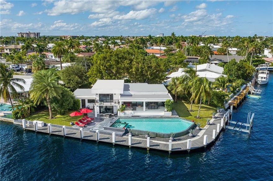 Set against an idyllic waterfront backdrop, this modern marvel on a point lot celebrates substance & style under one roof. Bright, open spaces throughout the custom-built estate offers designer details that invite the outdoors inside- enjoy expansive waterfront views from every room. An impressive clean-lined gourmet kitchen features cutting-edge Thermador appliances and custom cabinetry. The upstairs master bedroom boasts modern and tranquil vibrance with its own private balcony. The exterior boasts 190' feet of waterfront with 180' of composite dock (ocean access and no fixed bridges) & 24,000 lb. boat lift on the East side. Infinity pool with expansive outdoor living spaces for entertaining. This impressive residence is offered fully furnished and move-in ready.