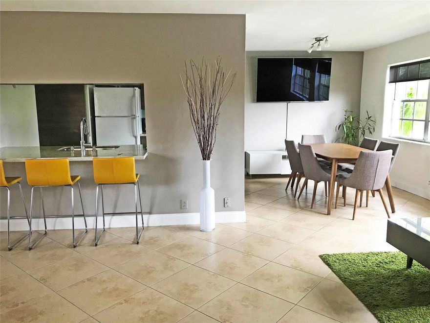 Beautiful Modern Deco Style Spacious Condo. Relaxing Lake and palm tree view. Renovated Bathrooms and Kitchen. Granite countertops. Plenty of storage spaces; Pantry and 2 closets in the living room. Water & Trash included. Assigned parking. Visitors parking available. Recently painted. Blackout curtains, roller shades and other curtains included throughout the apartment, which is Energy Saving. Main door entrance windows has blackout curtains. Living room windows have rollers shades. Breakfast area includes 3 bar stools. LED lights in the ceiling which are Energy Savers. Mirrors included in walk-in closet, second bedroom, 2 bathrooms. W/D in unit. New water heater, A/C, Washer & Dryer. Screened Porch to relax.  Located  close to shopping centers and major roads.