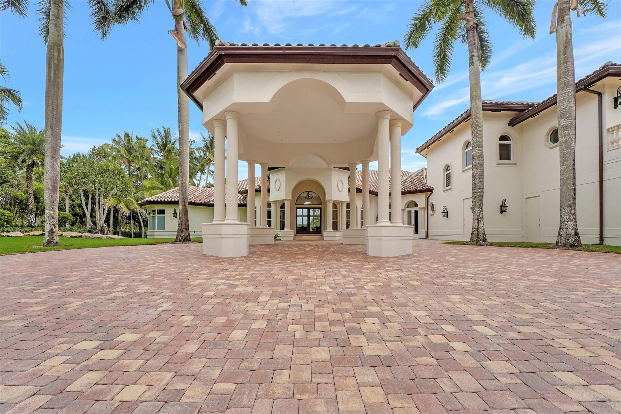 Exquisite luxury home within prestigious Windmill Ranch Estates. Grand entrance into the beautifully detailed & recently completed 7-figure remodel inside and out, w/ expansive lake views, lush landscaping, resort pool, & mature palm trees adorn this property. Unique masterpiece has fine craftsmanship, exquisite finishes, high volume ceilings, Jerusalem Stone, real wood floors, private office, outfitted bar, & formal dining. Gourmet kitchen, granite tops, custom cabinetry, massive center island & breakfast area. Lavish primary suite with large walk-in closets & resort style master bath w/ oversized Jacuzzi Tub, dual showers with full Steam. Cabana bath w/spa sauna & shower. Fully equipped Summer kitchen gazebo seats 20+. Oversized 3 car garage with marble floors, & expansive driveway.