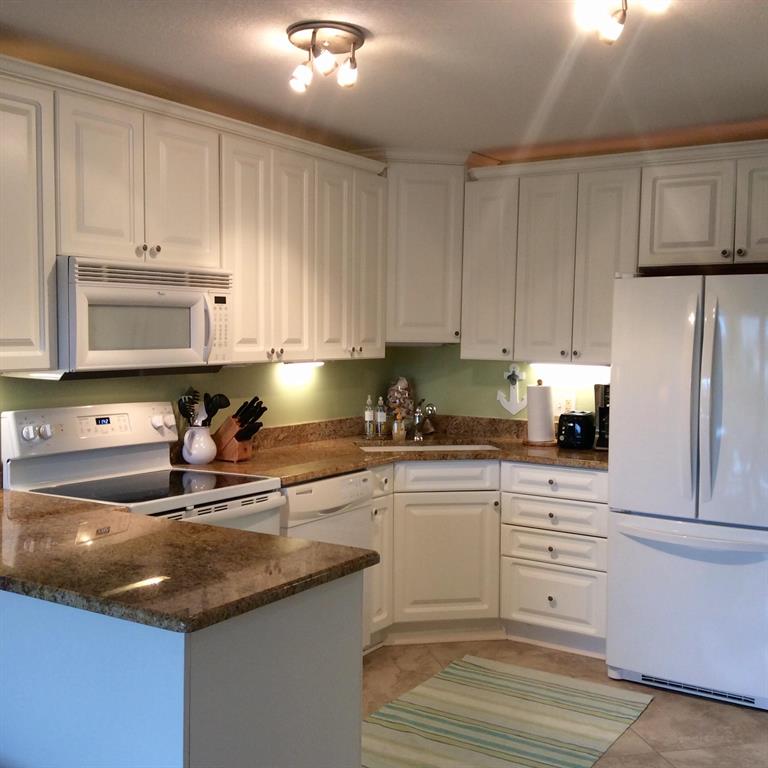 Perfect one bedroom one bath condo in the desirable gated community of Ocean Village. Updated kitchen and bath with newer cabinetry, granite counter tops and tile floors through-out. Comes fully furnished and turnkey with modern beachy chic decor complete with impact glass sliders leading to the screened in patio. Located close to all amenities and just a short stroll to the beach. Enjoy 4 heated swimming pools, golf, tennis, bocce ball, shuffleboard, pickleball and much more. Onsite oceanfront restaurant and lively tiki bar by the main pool. An ideal vacation home or investment property - Come see it today.
