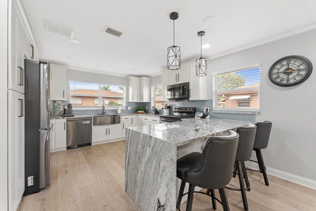 Photo of 703 Whippoorwill Lane, Delray Beach, FL 33445 (MLS # R11133605)