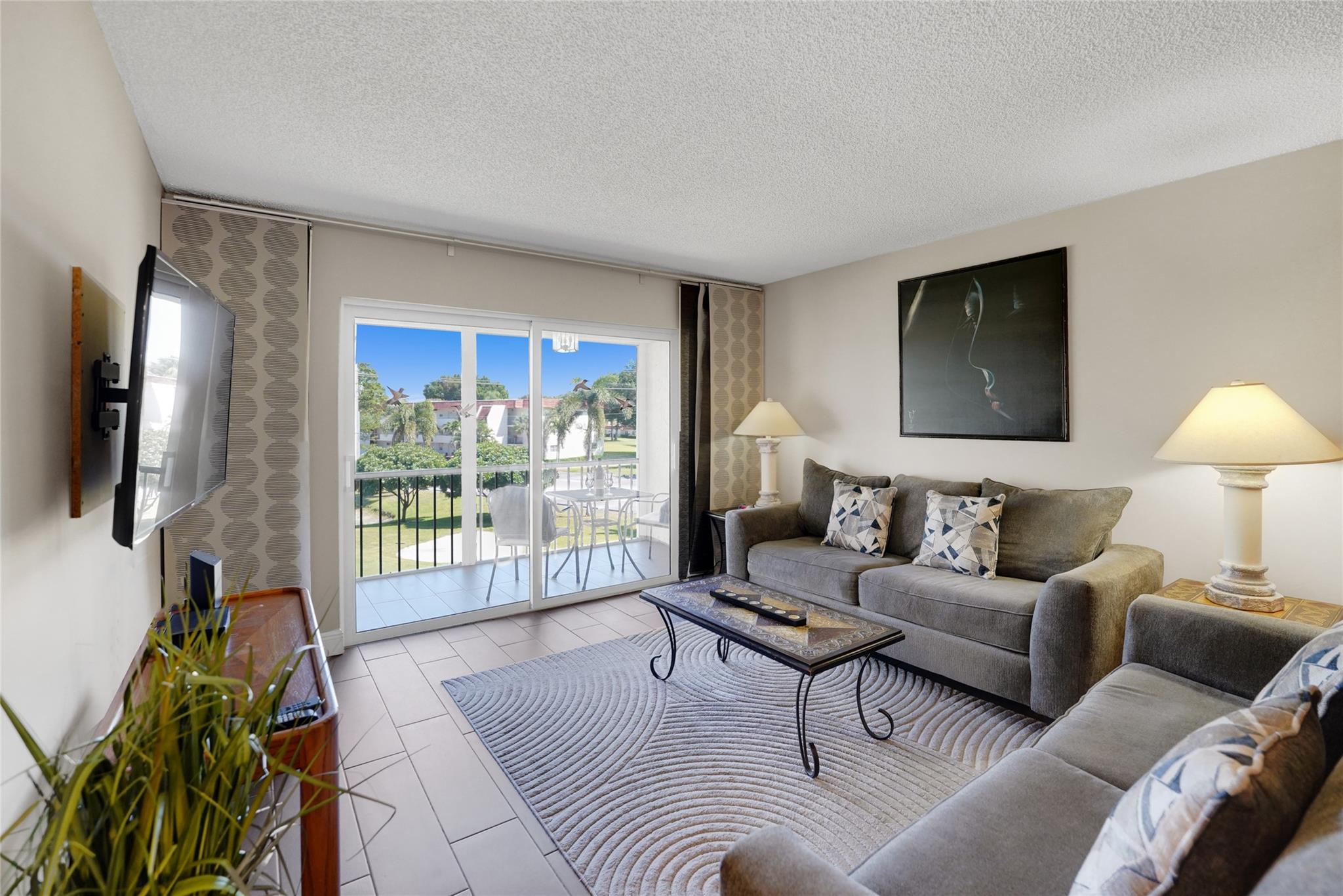LOCATION, LOCATION, LOCATION! This beautifully remodeled 2-bed, 2-bath condo is ideally situated near the clubhouse in the highly desirable Hollybrook Golf & Tennis Club. Located on the 3rd floor, it offers a serene garden & golf course view from your private, screened-in patio. For added safety, it features a reinforced steel entrance door, along with impact windows and sliding doors. The updated kitchen boasts ample counter space, and a brand-new A/C ensures year-round comfort. Fully furnished and move-in ready, this home provides incredible amenities, including free golf on two 18-hole courses (cart fees apply), pickleball, tennis, heated pools, library, sauna, vehicle wash area, and electric car charging stations. ALSO AVAILABLE FOR 6 MONTH SEASONAL RENTAL