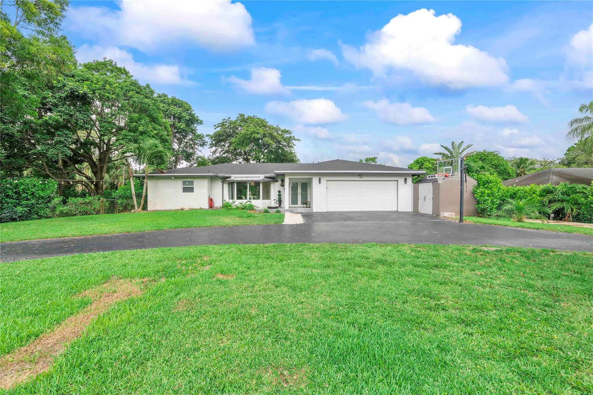 Fully Renovated 4/3 home sitting on over an acre of land in prestigious Pine Tree Estates – No HOA! Recent upgrades include a 2024 roof, newer impact windows and doors, a 2024 air conditioning unit, and custom-built closets installed in 2024. The interior features newly installed drywall with smooth wall and ceiling finishes, complemented by sleek modern baseboards and upgraded decorative interior doors. All bathrooms have been renovated with contemporary finishes. Additional highlights include a marble front porch, a resurfaced pool and updated marble pool deck, stylish tile flooring throughout (no carpet), and a reverse osmosis water filtration system. This home combines upscale upgrades with the freedom of no HOA restrictions—an exceptional opportunity in an elite neighborhood.