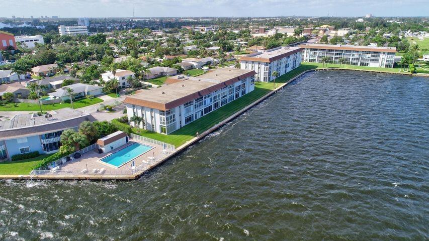 ALL ABOUT OUR BACKYARD & THE WIDE WATER VIEWS! THIS WELL MAINTAINED GATED COMMUNITY IS STILL THE BEST KEPT SECRET,ALONG THE INTRACOASTAL. LOCATED JUST NORTH OF BLUE HERON BLVD, EAST OF US 1. THE CAPTIVATING VIEWS THAT CAN BE SEEN FROM THE MOMENT YOU WALK IN, AND THRUOUT THIS 2BR/2BA UNIT WITH A GLASS ENCLOSED BALCONY FOR EXTENDED LIVING OFFERS LAMINATE FLOORING IN LIVING & BEDROOMS AND TILE IN KITCHEN & BATHS. MASTER BEDROOM IS LOCATED ON THE WATERSIDE W/ SLIDERS OPENING TO THE BALCONY, WAKE UP TO GLORIOUS SUNRISES. ENSUITE MASTER BATH W/FULL WALK IN CLOSET. GUESTROOM & GUEST BATH LOCATED OFF LIVING AREA . AN INTERIOR UTILITY CLOSET WILL ACCOMADATE A STACK FRONTLOAD W&D IF YOU CHOOSE. ADDITIONAL STORAGE LOCKER, COMMON LAUNDRY AVAILABLE. HEATED POOL ON THE INTRACOASTAL, WITH GRILL AREA.