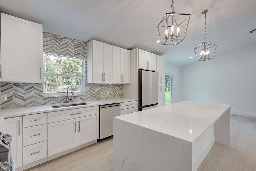 Accepting backup offers, to this completely model home in beautiful Jupiter farms. This has new hurricane windows, new hurricane windows. New dream kitchen, new bathrooms, new flooring, new appliances new high end water system, newer metal roof. 2019 septic. The list goes on and on. The kitchen is a chefs dream come true with vaulted ceilings, all top end appliances, a 8 foot quartz center island with water fall. The master bedroom and bathroom has vaulted ceilings with a on suit that is like a spa, with a jet shower tower and a 8 foot shower. the property is fenced in and high and dry. This home is made for entertaining a must be seen home.