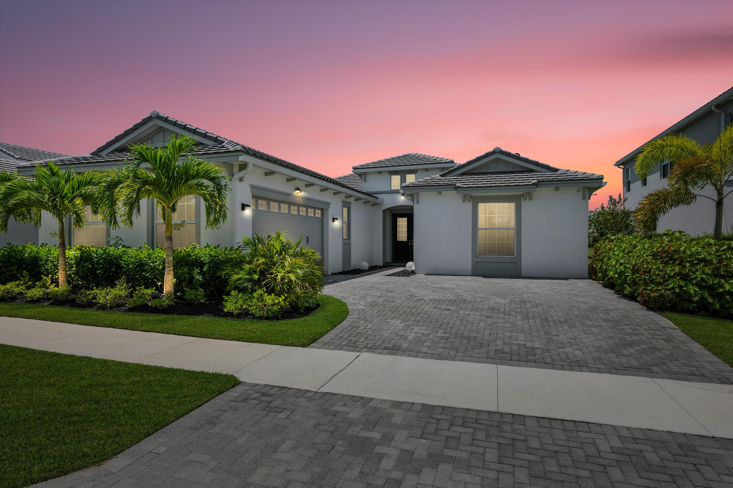 Welcome to this stunning Sandhill model in the desirable Orchards community of Westlake. Offering 3 bedrooms, PLUS a den/office, 3 bathrooms, and a 2-car garage, this home spans 2,410 sq. ft. of thoughtfully designed living space and sits on a beautiful lake view lot. From the moment you arrive, the curb appeal stands out with modern black double doors that open to a bright and inviting interior. White walls and tile flooring flow throughout the main living areas, creating a fresh and airy atmosphere. The living room is filled with natural light thanks to expansive sliding glass doors that frame the picturesque lake views.