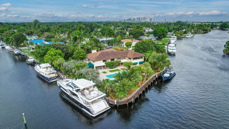 This rare & unique point (almost full acre) offers a valuable blend of deep water dockage! 540ft+/- waterfront & serene wide views of the New River it is an irreplaceable opportunity! Walled & gated at the end of a semi-private street. Park-like setting overlooks Secret Woods Preserve & inspires private island resort ambiance with a large pool, Cabana Bath, Summer kitchen & covered terraces. Residence itself is concrete built & substantial with easy flowing indoor & outdoor entertaining areas, flexible floorplan, a gourmet kitchen & expansive bedroom suites, updated custom baths. Luxurious Primary Suite offers expansive terrace. New South dock connects to the West side dockage creating a continuous walkaround dock with new power pedestals & underwater lighting. Potential Seller Financing!