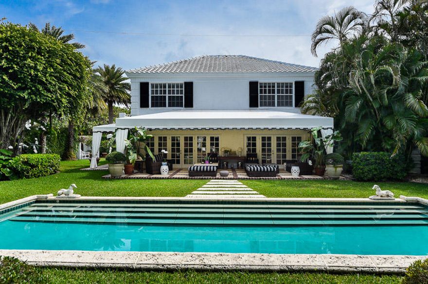 This is the epitome of the sublime, Palm Beach home, situated less than 100yds from the beach, with a private cabana. A day dock on the ICW, with the lakeside bicycle path nearby. The large garden is filled with lush, verdant trees, plants and lawns and is peppered with perfect spots to sit, relax and enjoy the tropical environment. This beautiful space is anchored by a stone-edged, stepped pool and an adjoining covered patio, perfect for outdoor dining. The house is light and airy, with a library, separate dining room, spacious living room and a more casual living area, with TV etc., which accesses yet another loggia and patio.